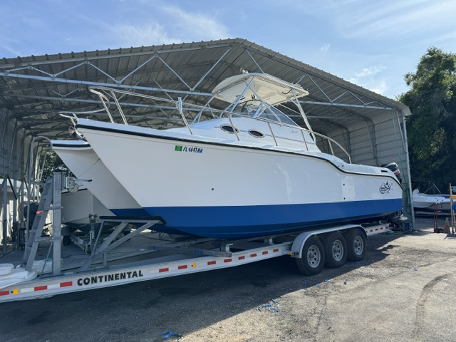 Marine technician working on fiberglass boat repair