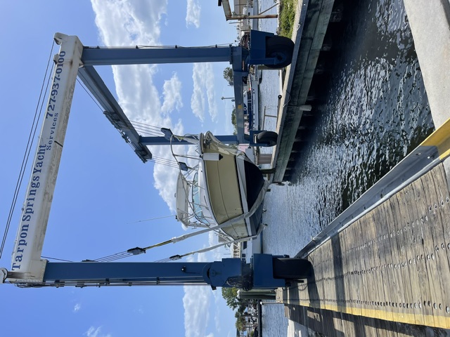 Marine technician working on a boat at the dock